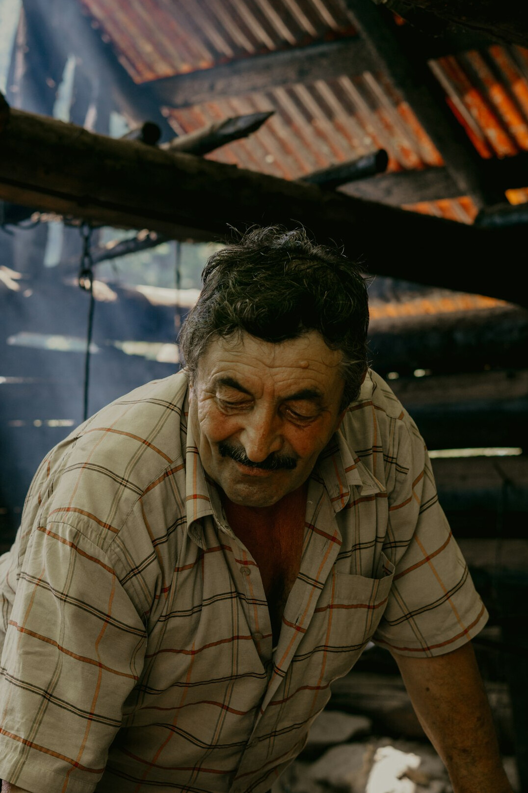 Portrait of a bearded man in his early forties wearing a light shirt